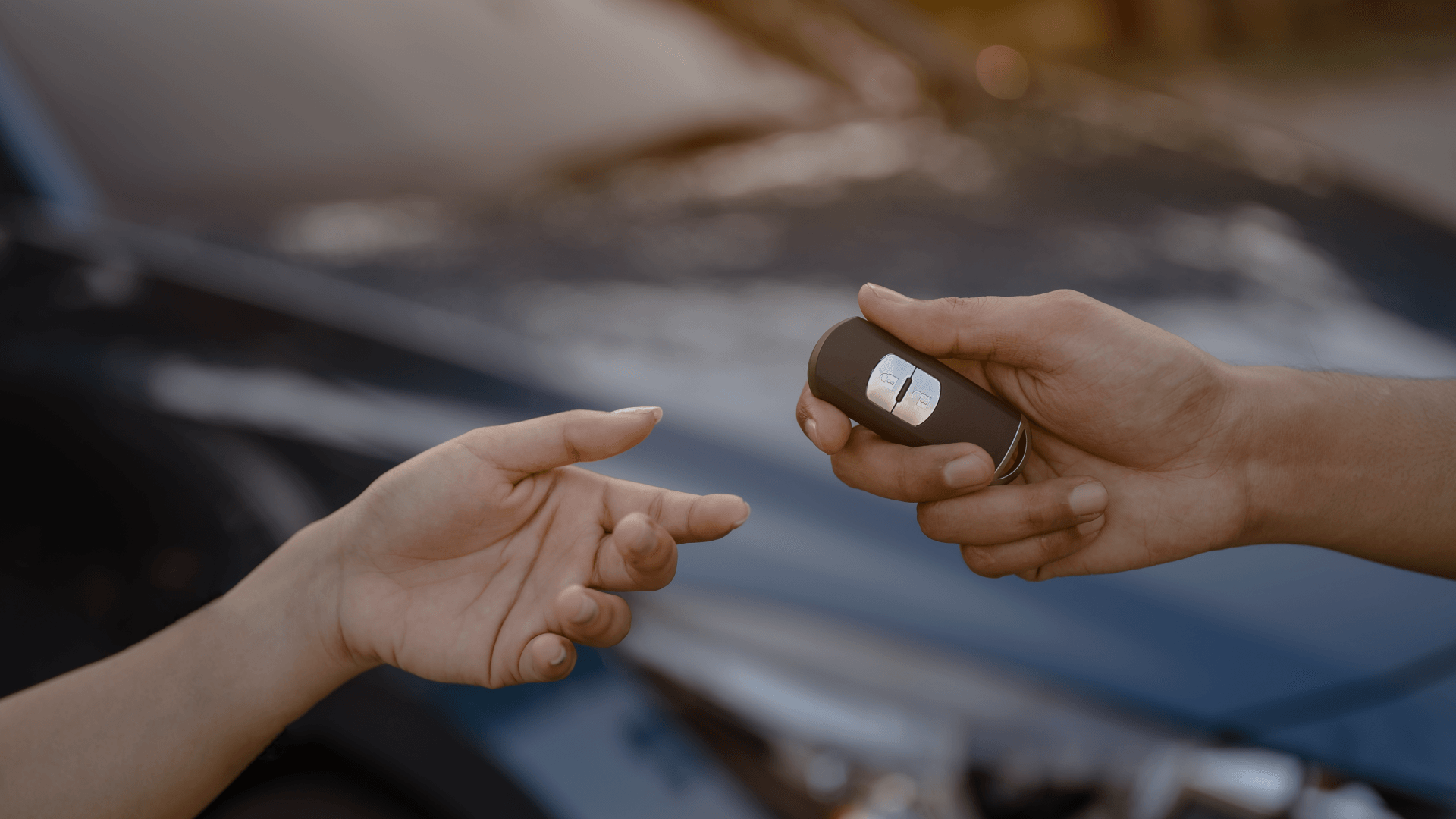 close-up-woman-holding-new-car-systems-key-of-blue-2023-11-27-05-34-07-utc 2